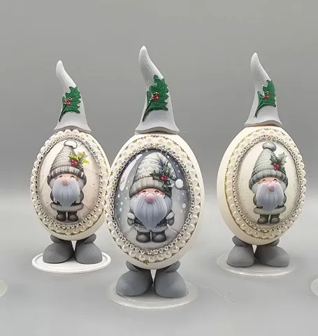 A photo of three decorated eggs with a depiction of gnomes